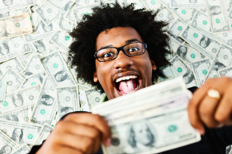 an excited person holding money