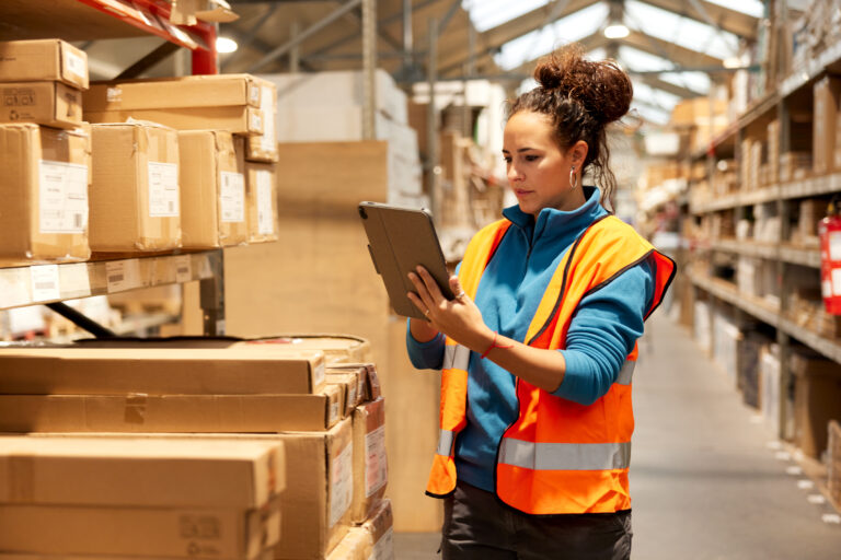 a worker in a warehouse takes inventory getty