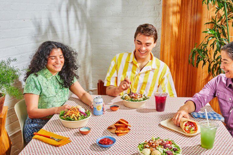 cava lifestyle picture showing three diners at a restaurant