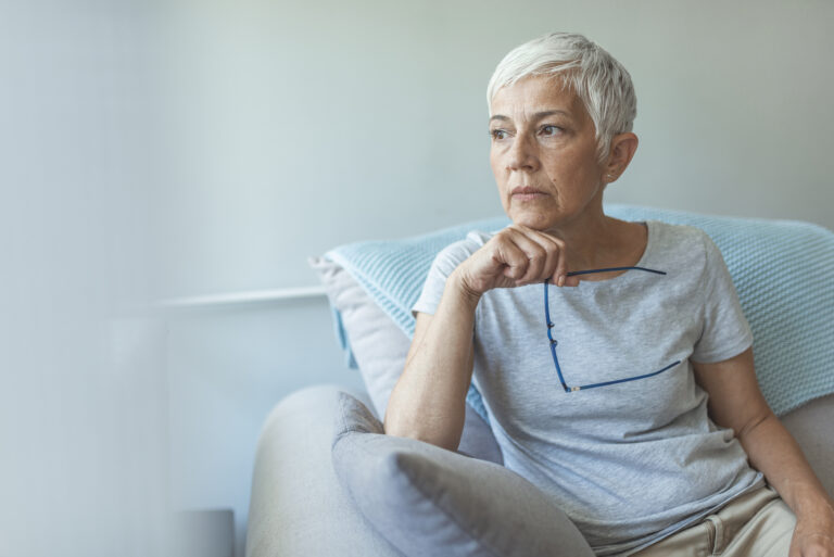 senior woman worried holding eyeglasses gettyimages 1162818693