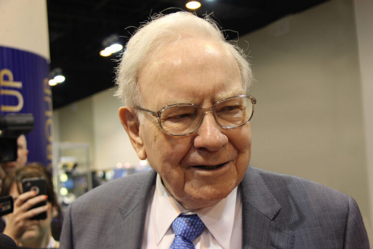 a candid shot of warren buffett looking away from the camera