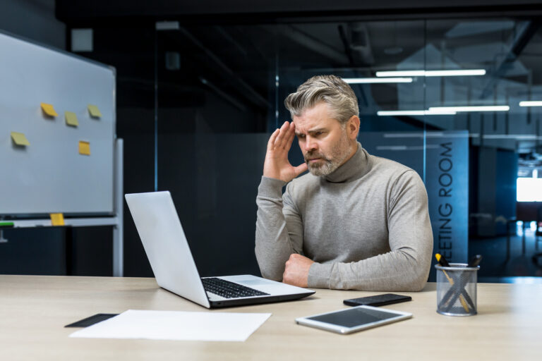 investor seems upset looking at computer frustrated