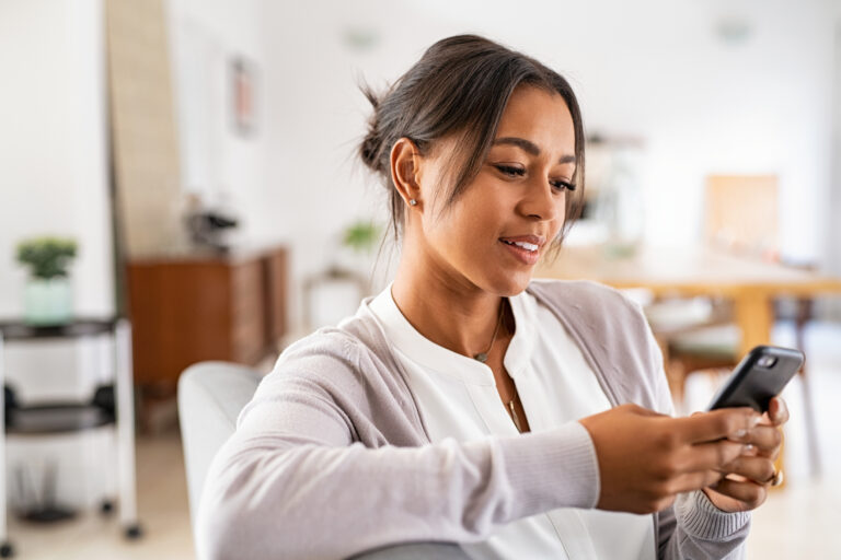 person looking pleased while gazing at a smartphone