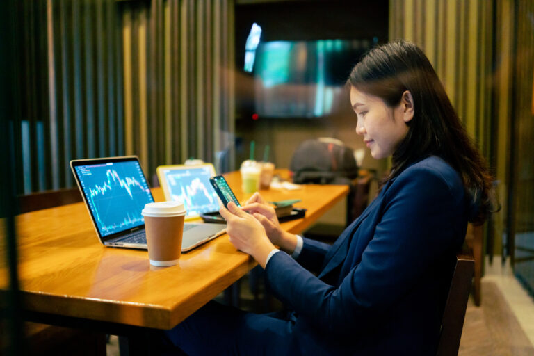 person using a laptop and tablet simultaneously