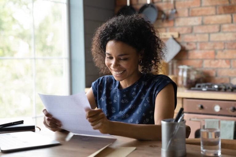 person smiling while opening mail 2eXwb6W