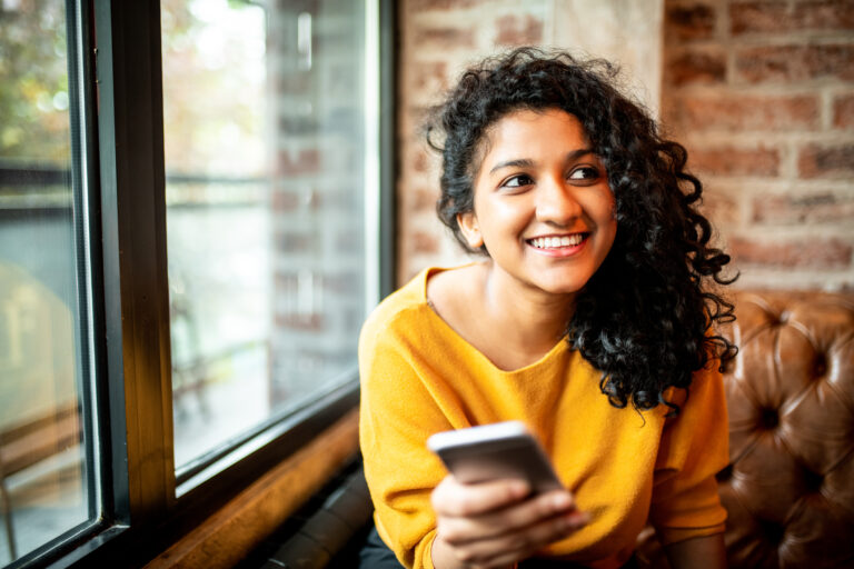 smiling person with phone