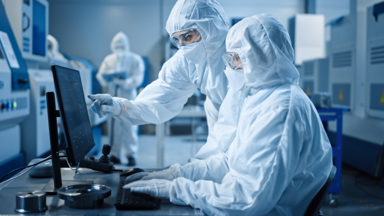 technicians in lab wearing protective gear looking at computer 1200x675 c2b5ff2