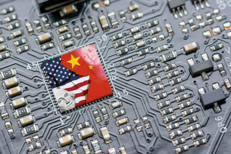 us and chinese flags superimposed on a semiconductor