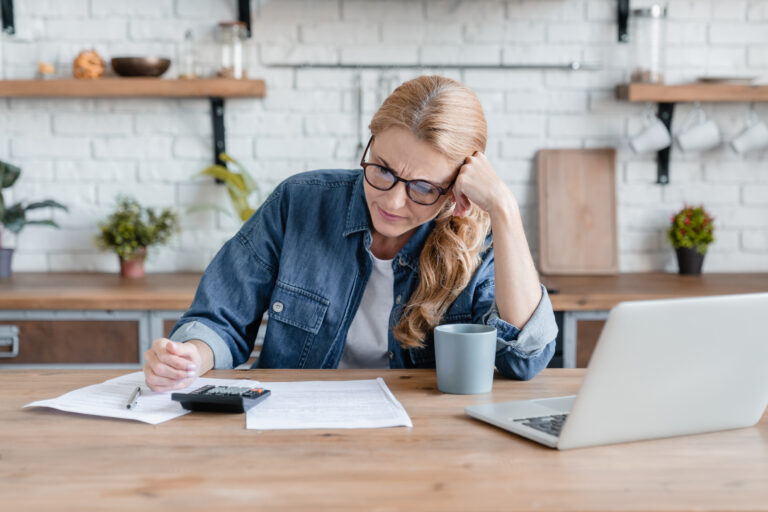 woman working on taxes at her desk