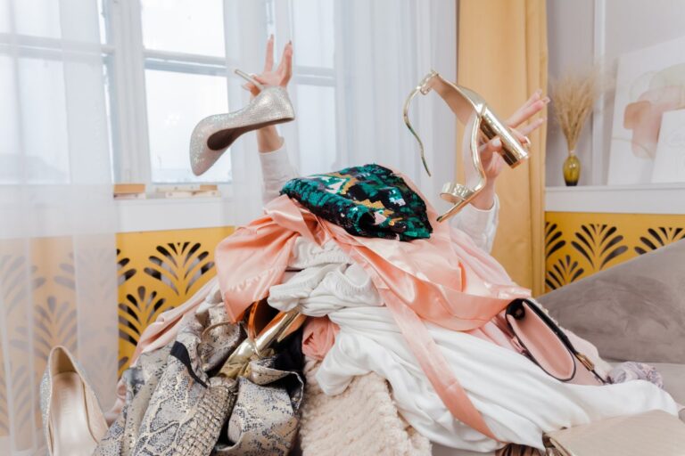 Woman s hands coming out of pile of clothes