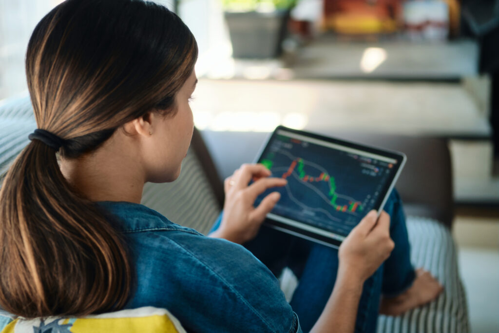 a person looking at a stock chart on a tablet