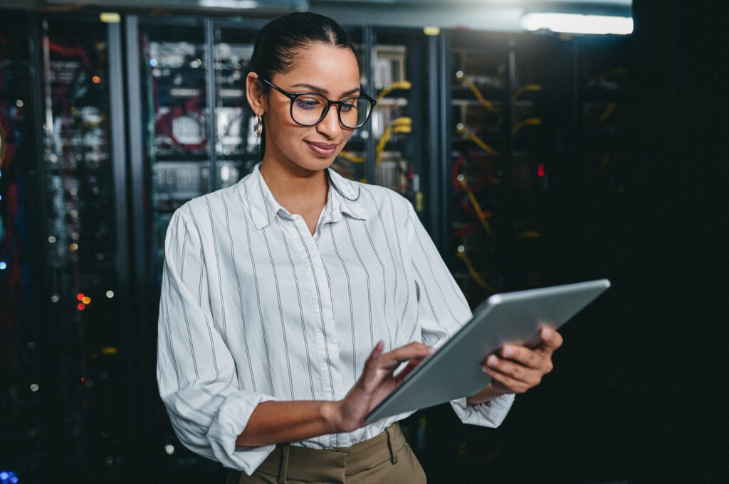 person in a data center using a tablet computer