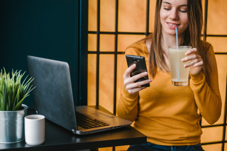 woman drinking lemonade on phone