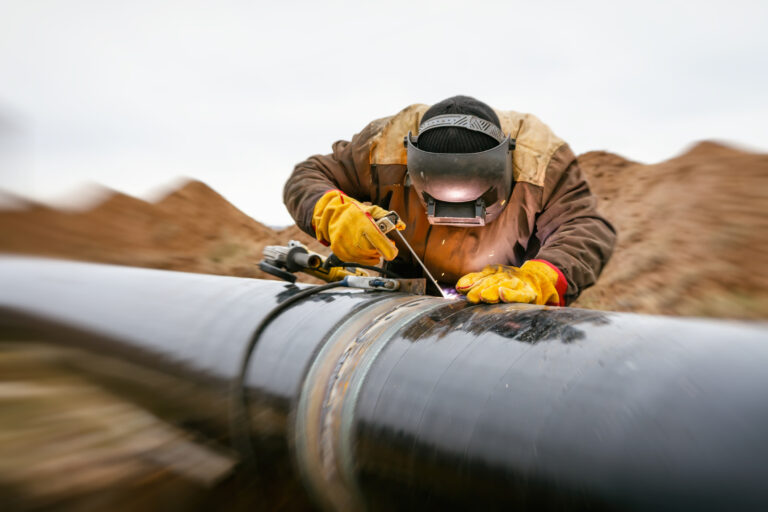 22 06 14 a person in protective gear welding an energy pipeline gettyimages 1130949180