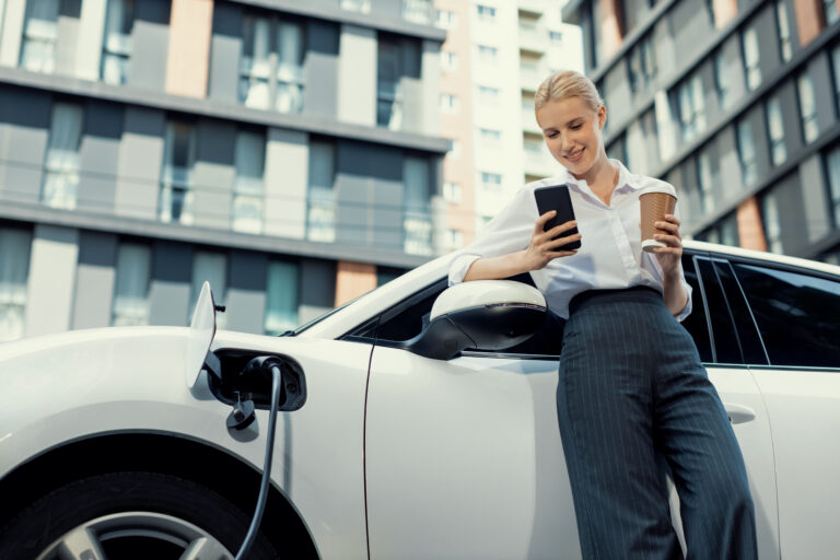 a woman charges an ev