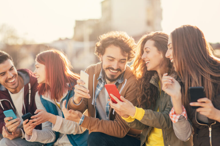 friends looking at mobile phones gettyimages 833004468