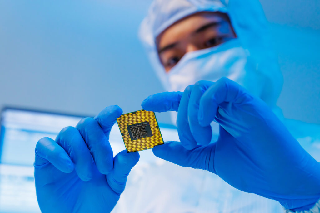 person in a mask looking at a semiconductor microchip for artificial intelligence ai