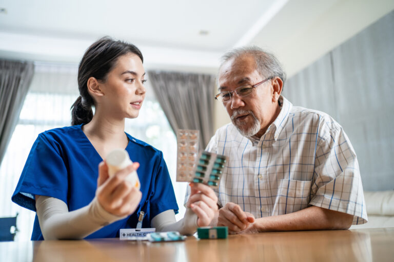 physician giving medicine to elderly patient