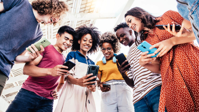 students looking at their phones together