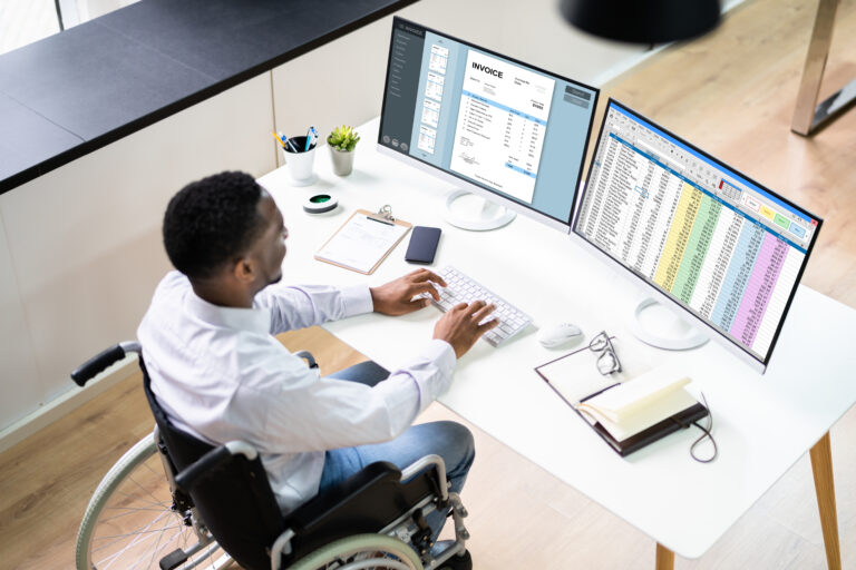 1737017629 man sitting in front of two monitors