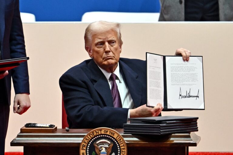 President Trump holding up executive order