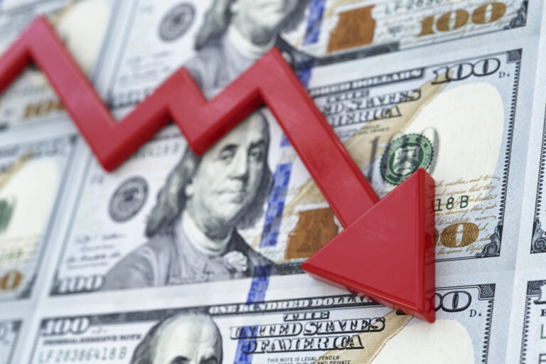 downward red arrow with a background of us currency