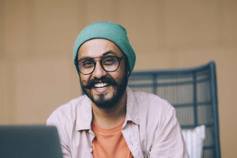 getty happy smiling beard at laptop