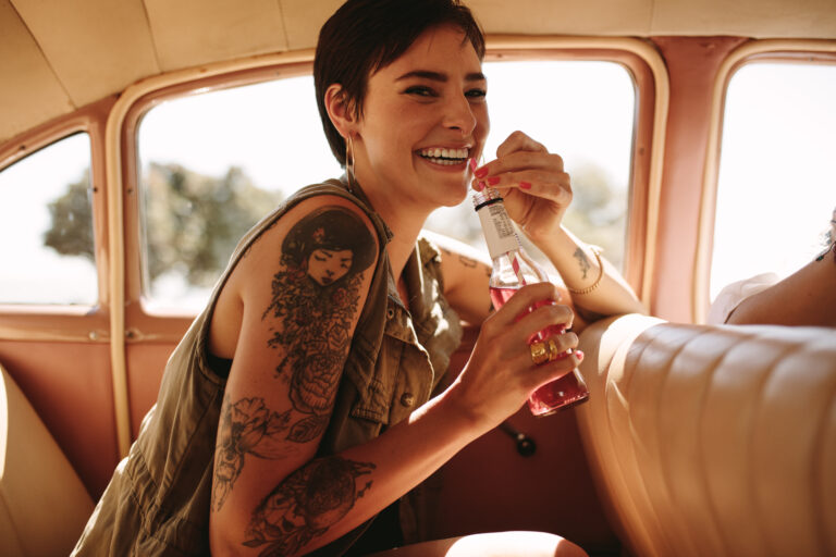 person drinking bottled drink through a straw