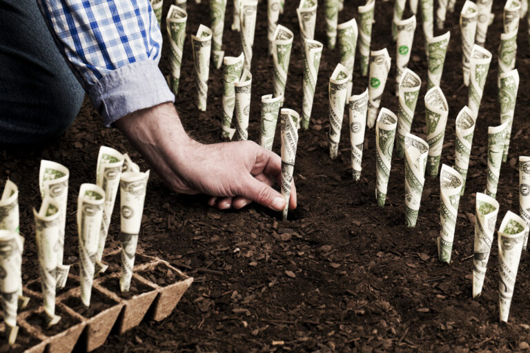 22 08 22 a hand planting money in the ground to show long term investing growth mf dload