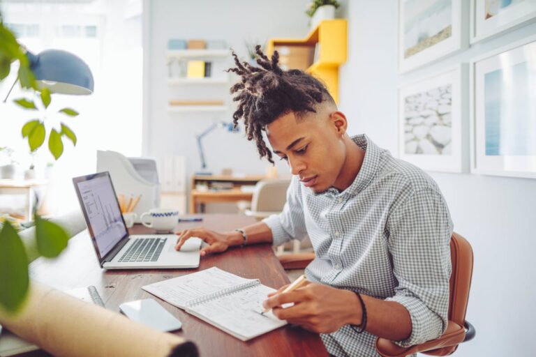 Young man looks over his investment accounts HS5MyzT