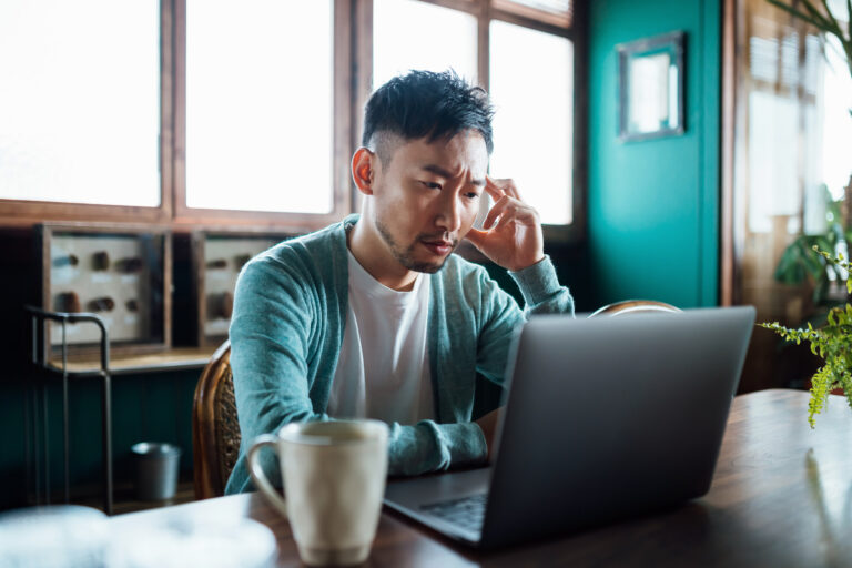 concerned unhappy person staring at laptop