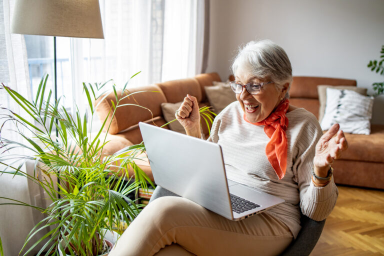 excited person looking at laptop