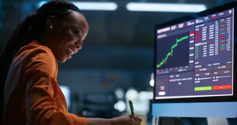 investor looks at a financial chart on a computer screen