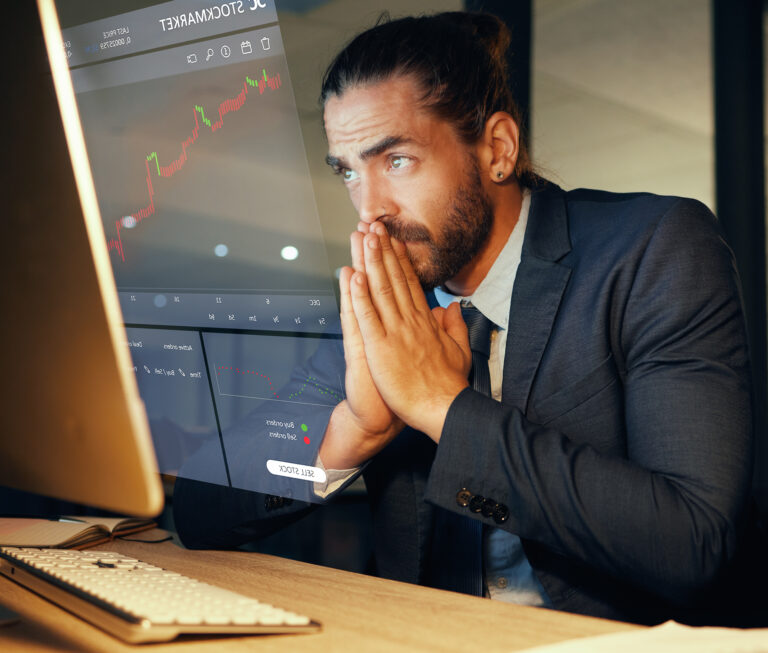 investor prays at desk