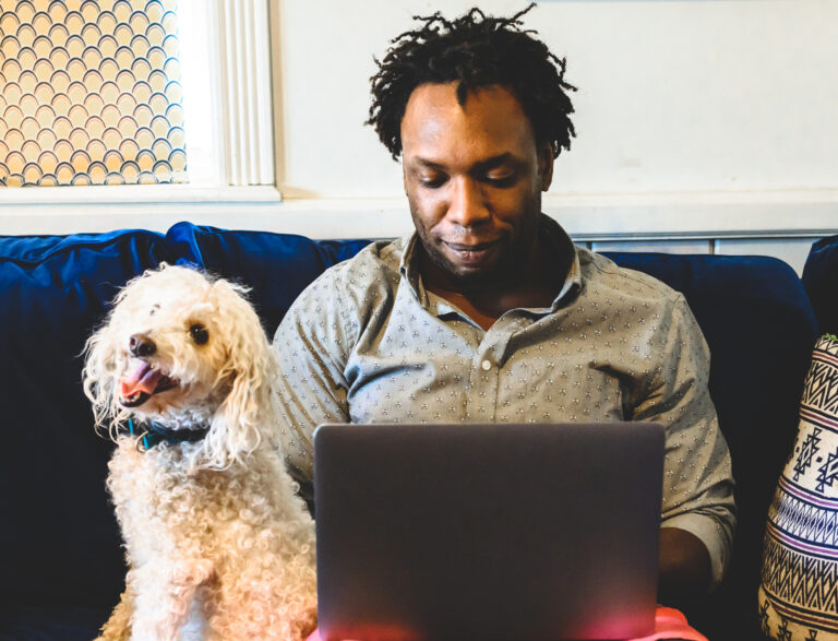 investor sitting with laptop and dog