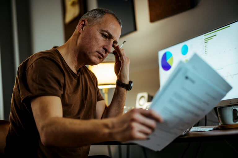 middle aged man serious looking at documents