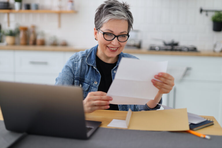 older woman document laptop gettyimages 1479451366