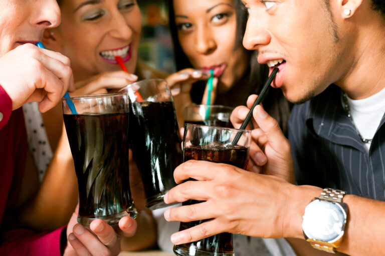 people drinking cola with straws