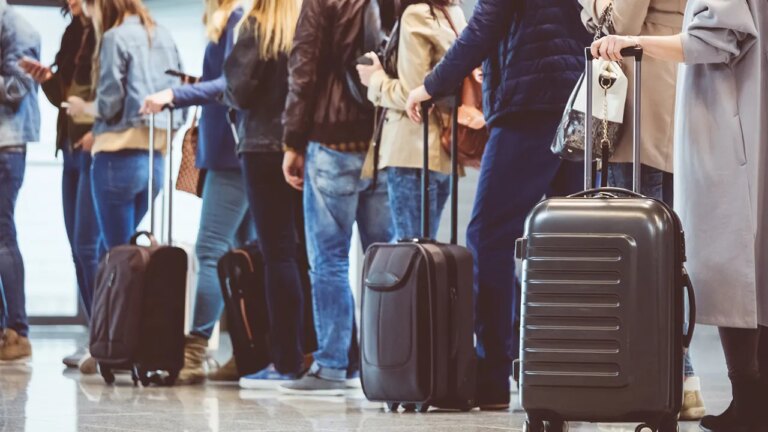 people in airport waiting in line