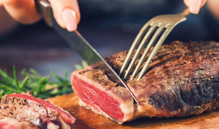 woman cutting steak