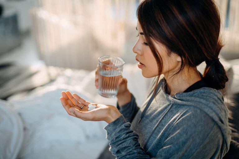 woman holding pills