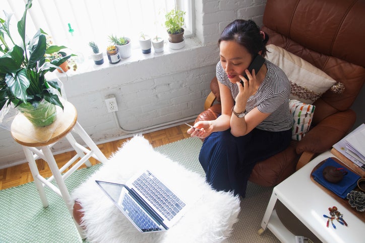 woman on phone with credit card and laptop 6yvYAto