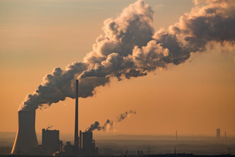 Steam and exhaust rise from a power plant