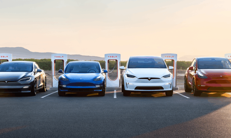 4 teslas in a line at a charging station