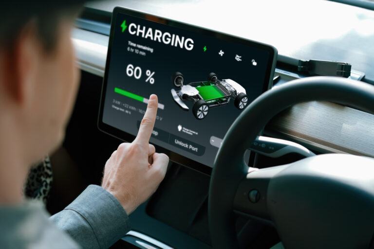 person uses touchscreen in ev that is charging getty