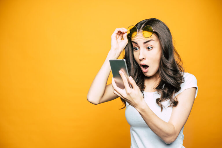 shocked investor with smartphone