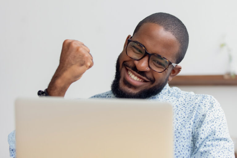 smiling man holding fist up