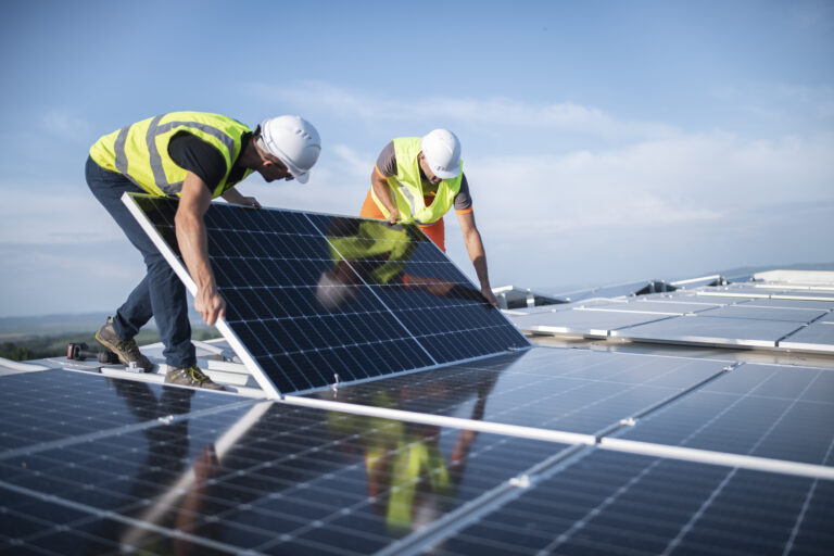 two technicians installing solar panels 1405880267
